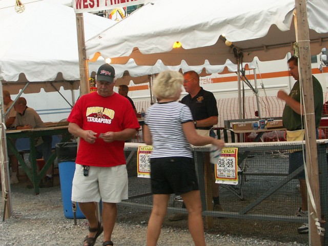 Frank Saunders and Patrick Saunders watch as fair goers try their luck at the Nevada Stand.