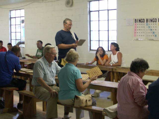 William Spicer verifying a player's winning Bingo card.