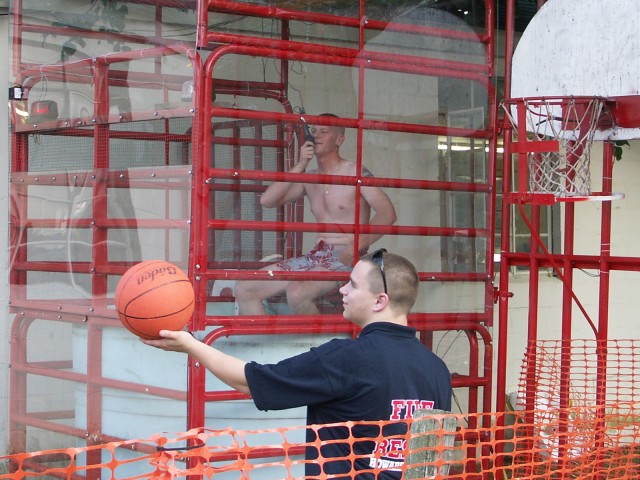Lt. Jon Trenary waiting to be dunked, and Brandon Blankenship waiting for a basketball shooter.