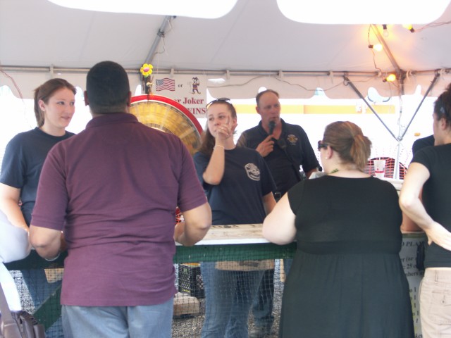 Mel Edwards, Christy Smith, and Carl Buell working in the Money Wheel stand.