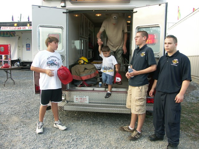 Chris Saunders, Matthew Saunders, and Brandon Blankenship assist at the recruitment booth.